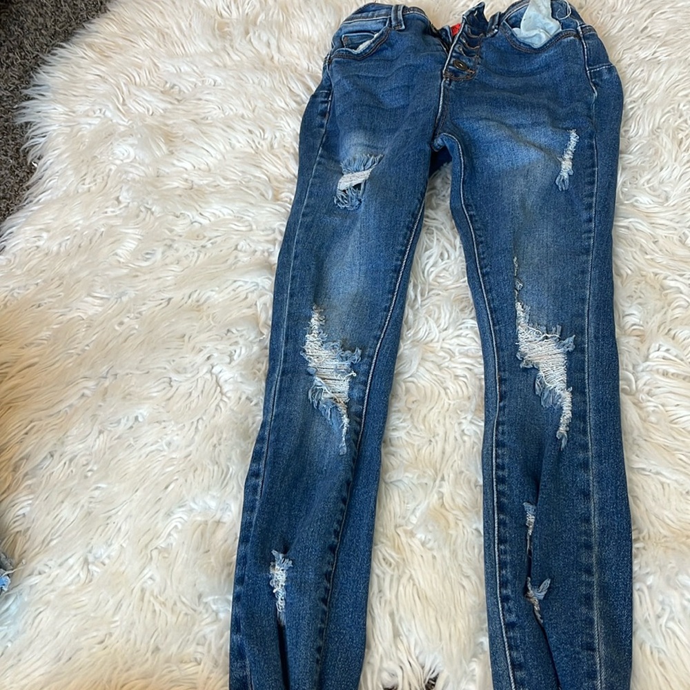 Dark blue ripped jeans, size one.